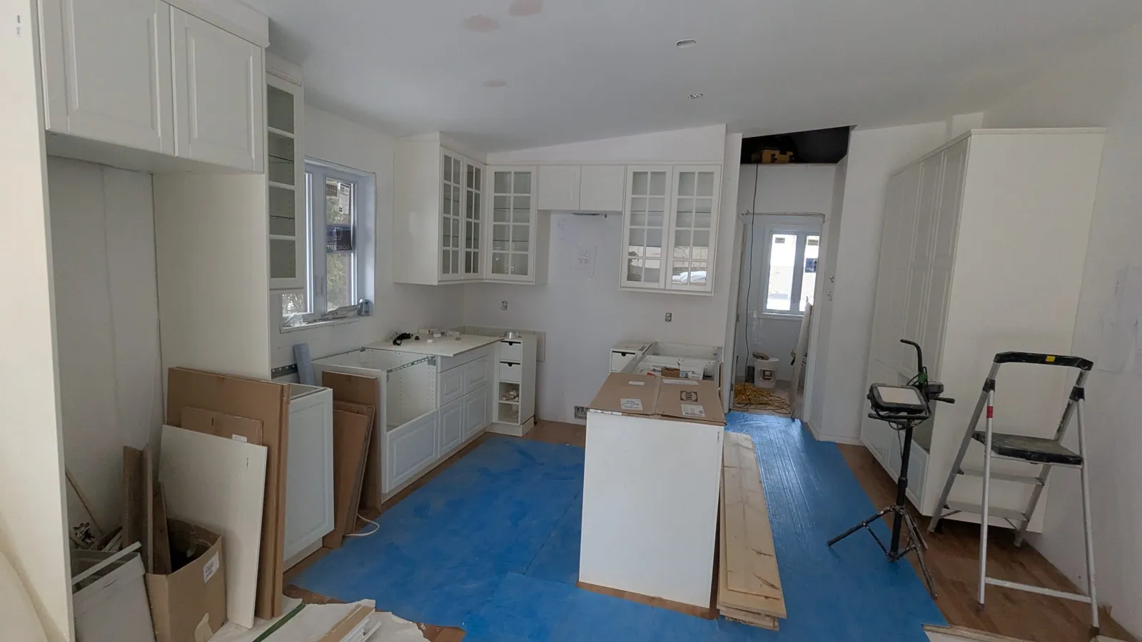 Kitchen island and shaker-style cabinets during installation in Deux-Montagnes